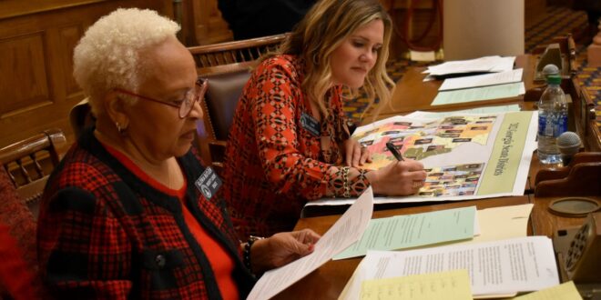 Sen. Elena Parent, right, takes on a map during the 2021 special redistricting session, while Senate Minority Leader Gloria Butler looks at notes.