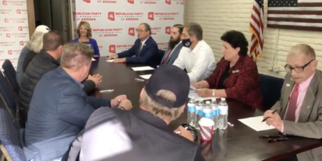 Arizona’s 11 fake electors sign a document in Phoenix on Dec. 14 2020