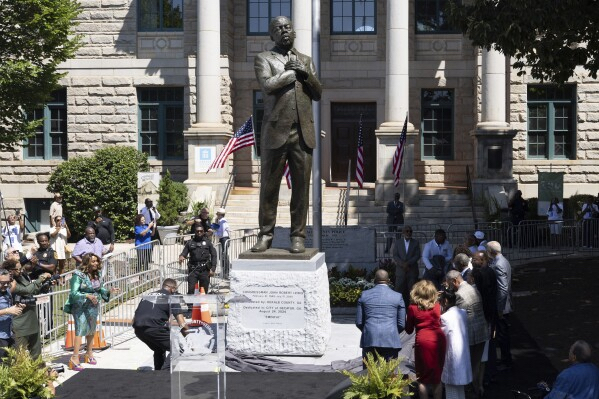 - Poli Alert John Lewis statue