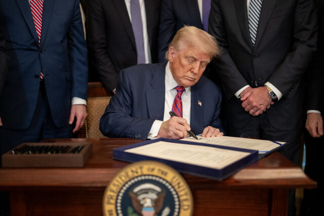 Trump - Poli Alert President Donald Trump signs S.1852, The GENIUS Act, Friday, July 18, 2025, in the East Room of the White House. (Official White House Photo by Daniel Torok)