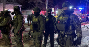 Federal Bureau of Prisons officers on the scene where a federal immigration agent shot a man in Minneapolis