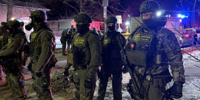 Federal Bureau of Prisons officers on the scene where a federal immigration agent shot a man in Minneapolis