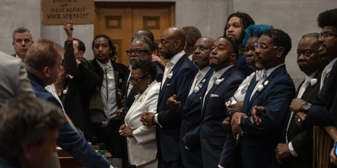 Tennessee Democrats lock arms on the Tennessee House floor in protest of a Republican redistricting vote that split up a majority-Black, majority-Democratic congressional district