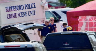 Police crime scene unit van labeled 'Biddeford Police Crime Scene Unit' at a cordoned area with investigators nearby