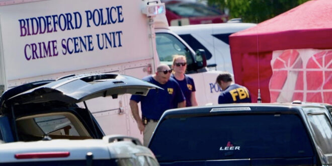 Police crime scene unit van labeled 'Biddeford Police Crime Scene Unit' at a cordoned area with investigators nearby