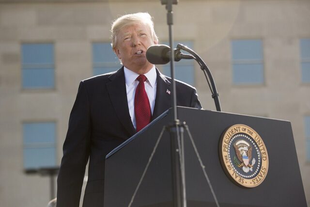 Donald Trump - Poli Alert Donald Trump speaking at a lectern, WHIP program