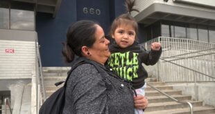 A mother and daughter are pictured at a protest against arrests of immigrants at green card appointments in Salt Lake City. Two lawsuits filed Monday challenge new federal guidance that could affect green card applicants who have used Medicaid or food assistance.